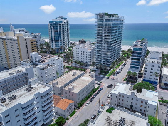 Panoramic view of buildings near a coastline with the ocean in the background.