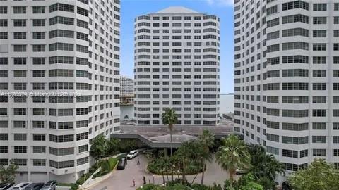 Front view of multiple high-rise buildings with a circular driveway.