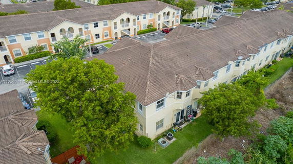 Elevated view of a residential building complex with tiled roofs and multiple units.
