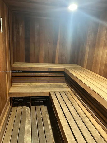 Interior view of a wooden sauna room with benches.