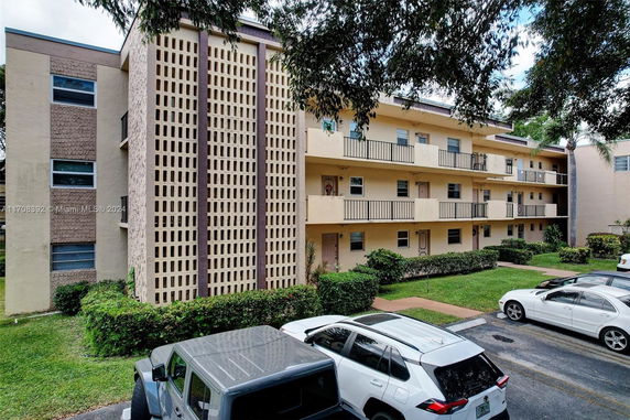 Front view of a multi-story residential building with balconies.