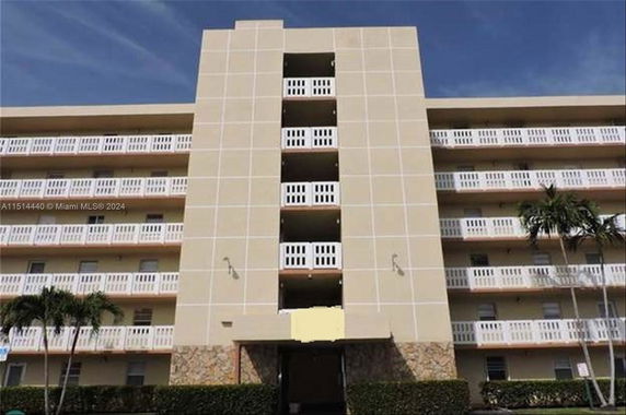 Front view of a multi-story residential building with balconies.