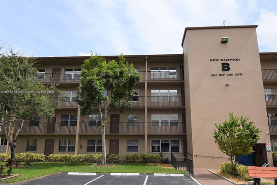 Front view of a multi-story residential building with balconies.