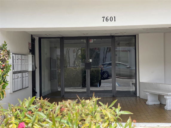 Entrance view of a building with glass doors numbered 7601.