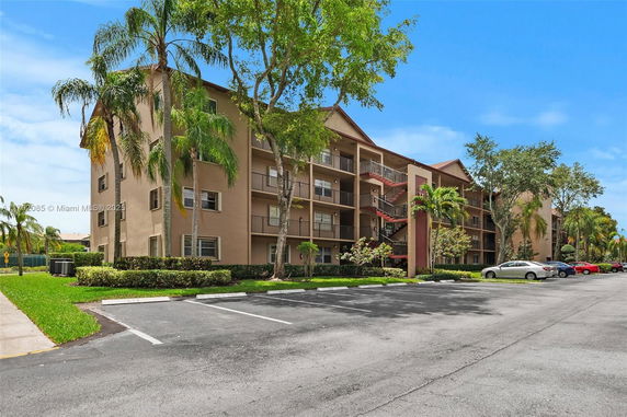Front view of a multi-story residential building with balconies.