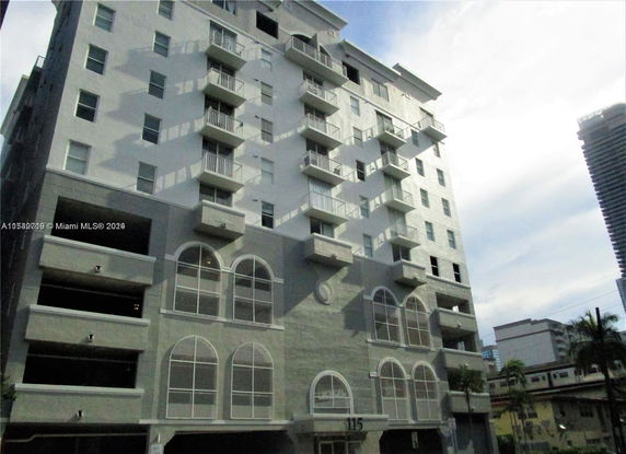 Front view of a multi-story residential building with balconies.