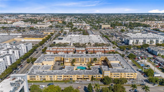 Aerial view of a residential complex with surrounding city infrastructure.
