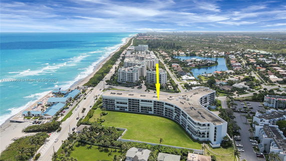 Aerial view of coastal residential area with high-rise buildings and oceanfront.