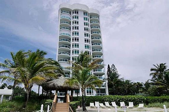 Front view of a multi-story apartment building with balconies.