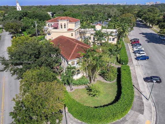 Front view of a multi-story house with a red-tiled roof.