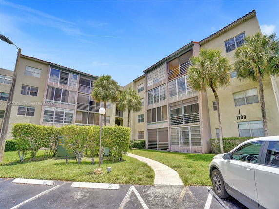 Front view of a multi-story apartment building with balconies.