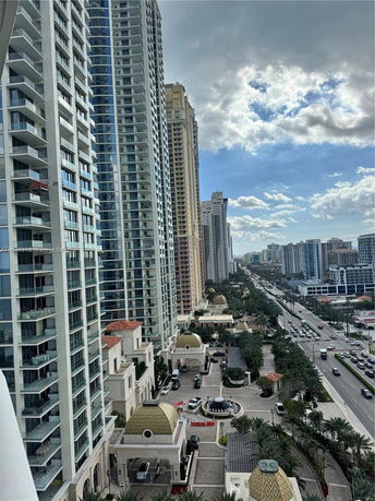 View of high-rise buildings along a busy street with surrounding urban landscape.