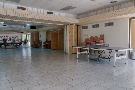 Interior view of a recreational space with a table tennis setup.