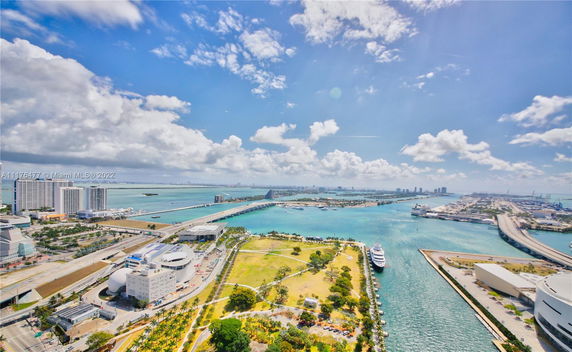 Panoramic view of a bay area with buildings, roads, and waterways.