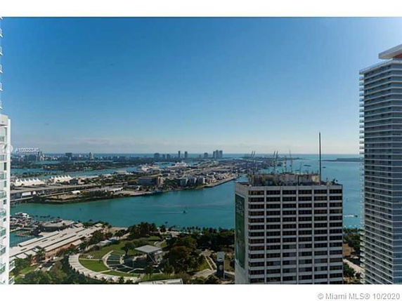 Wide angle view of surrounding buildings and waterfront area from a high vantage point.