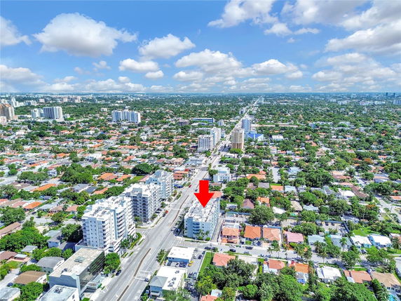 Aerial view of a densely populated urban area with multi-story buildings and houses.