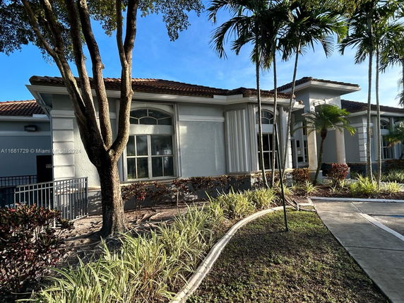 Front view of a modern single-story house with large windows and a tiled roof.