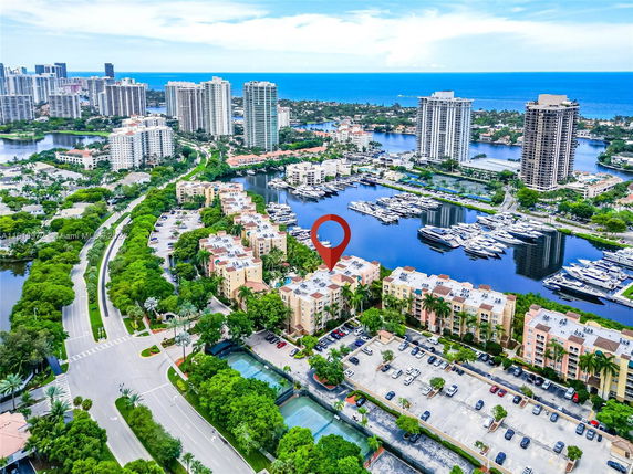 Aerial panoramic view of a residential area with nearby waterfront and tall buildings.