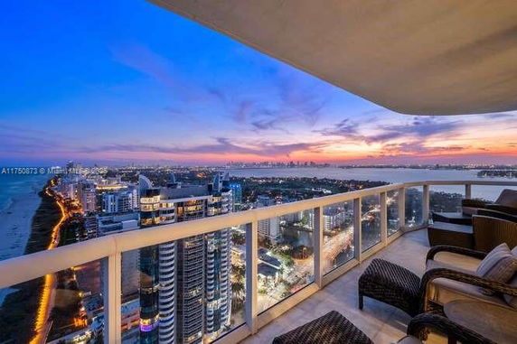 Panoramic view of a cityscape from a high vantage point during sunset.