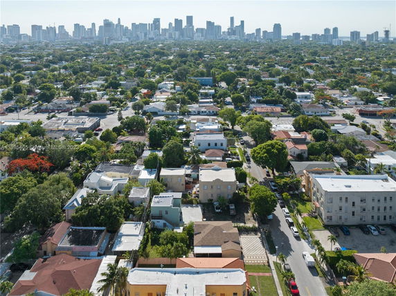 Panoramic view of a residential area with a city skyline in the background.
