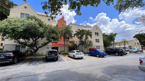 Front view of a multi-story building with a parking area.