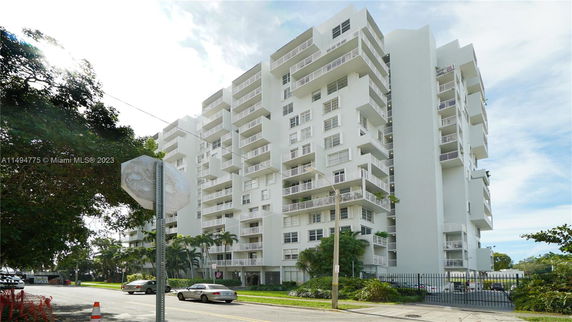 Front view of a multi-story residential building with balconies.