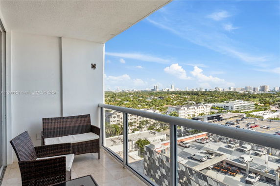 Balcony view showing cityscape and buildings in the distance.