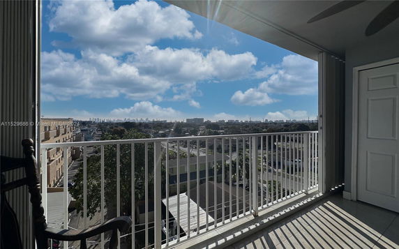 Panoramic view from a balcony overlooking cityscape and skyline.