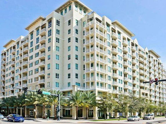 Front view of a multi-story apartment building with balconies.