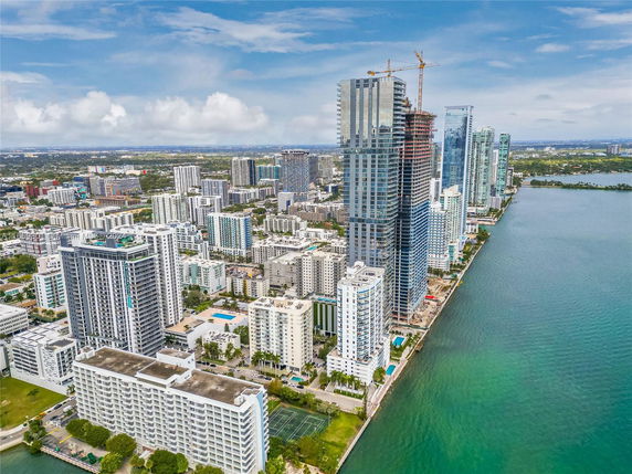 Panoramic view of a waterfront cityscape with high-rise buildings.