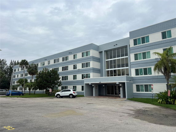 Front view of a multi-story residential building with a central entrance.