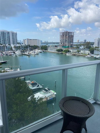 Panoramic view from a building showing boats on the water and surrounding cityscape.