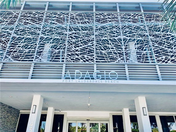 Front view of a modern building with intricate metal facade design at Fort Lauderdale Beach.