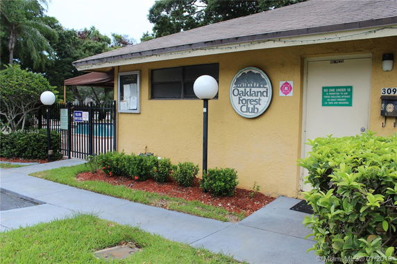 Front view of a building with a sign reading 'Oakland Forest Club'.