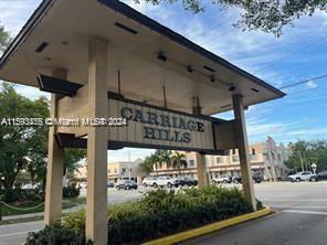 Front view of a large entrance sign for Carriage Hills.