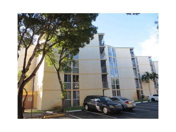Front view of a multi-story residential building with balconies.