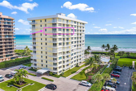 Front view of a multi-story beachfront building with balconies.