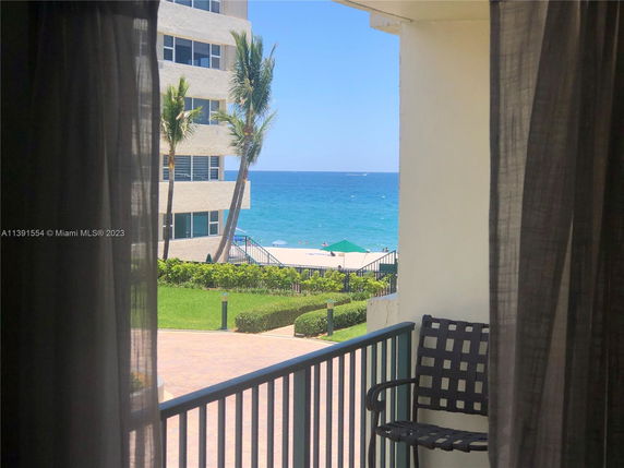 View from a building showing a beach and ocean in the background.
