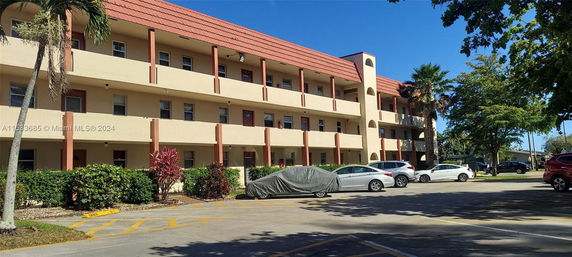Front view of a multi-story residential building with balconies.