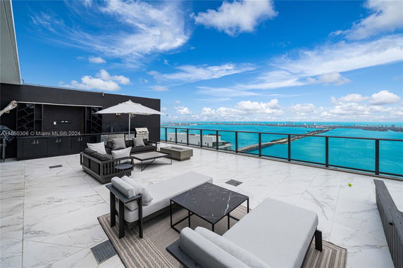 Rooftop with seating area and ocean view.