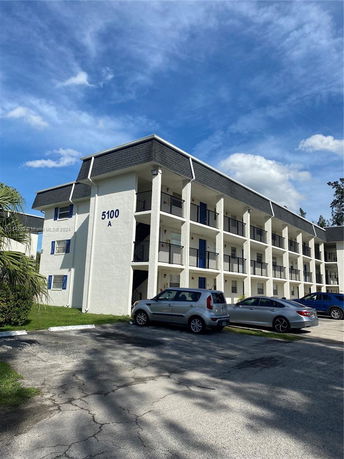Front view of a multi-story residential building with balconies.