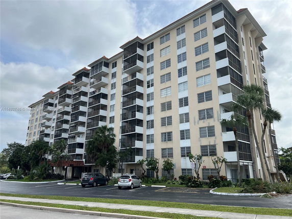 Front view of a multi-story residential building with balconies.