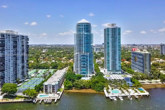 Aerial view of high-rise buildings near a waterfront.