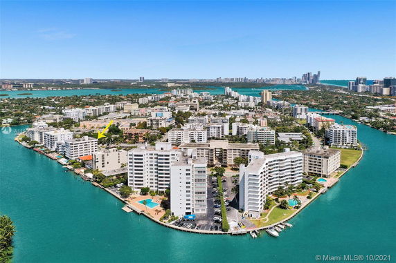 Panoramic view of a cityscape with numerous buildings surrounded by water bodies.