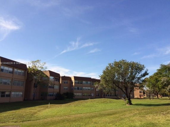 Front view of a multi-story building with multiple windows.