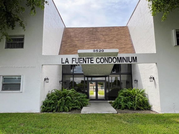 Front view of a condominium building entrance with a large sign reading 'La Fuente Condominium'.