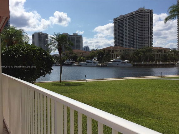 View of high-rise buildings and waterway with boats in the distance.