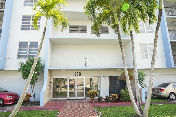 Front view of a multi-story building with glass entrance.