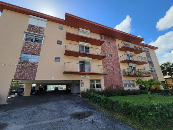 Front view of a multi-story residential building with balconies.