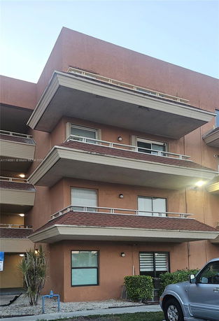 Front view of a multi-story building with balconies.
